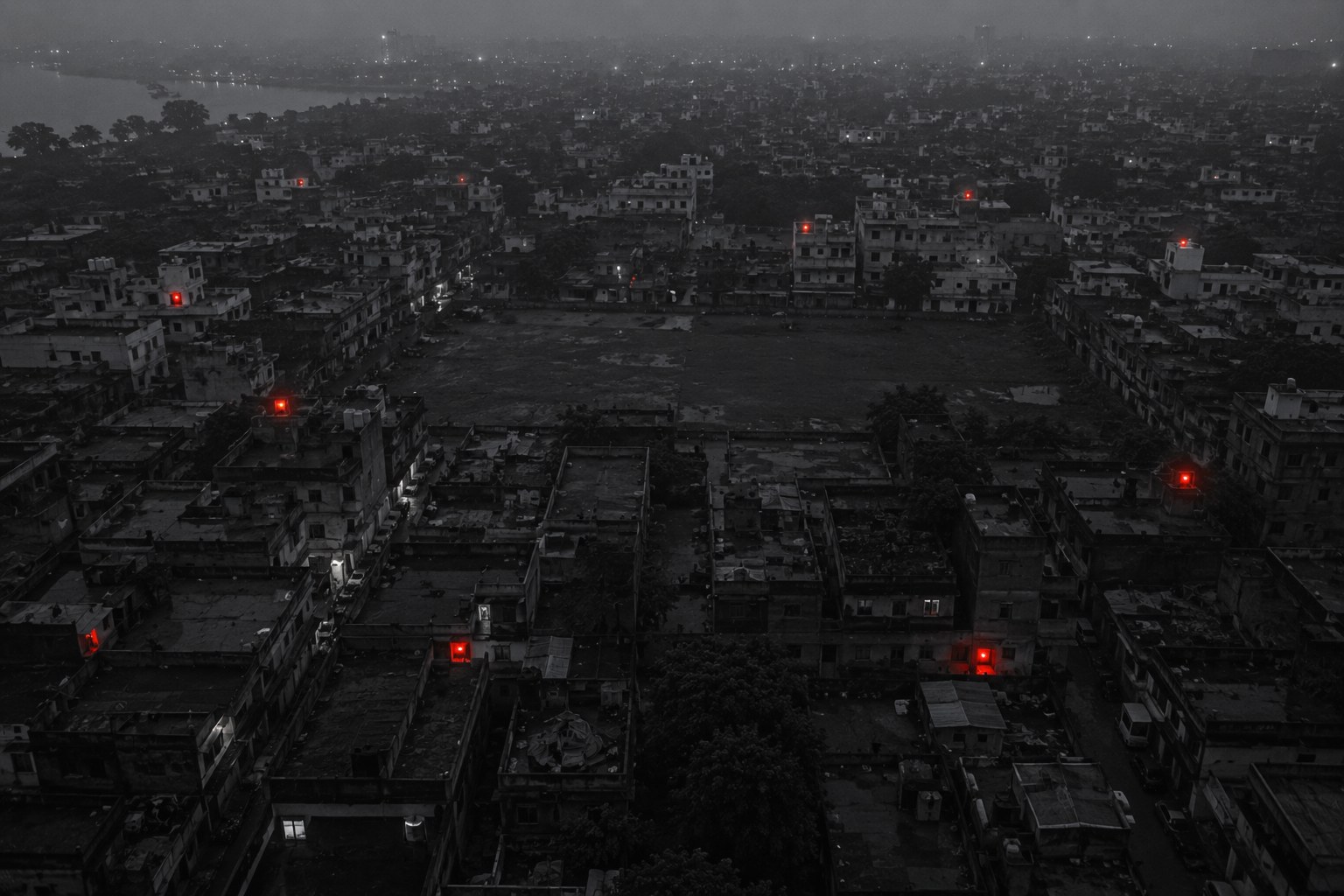 An aerial view of a dense neighbourhood at dusk, with scattered red points glowing on rooftops, none of them connected to each other.